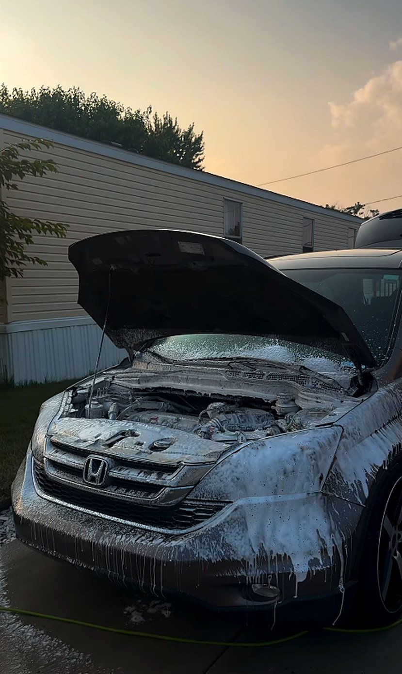 Honda CR-V with hood up, foamed at sunset